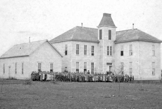 John Oats was the only player on the first football team who could kick the football over the school building. This is what the Dublin school looked like in 1898. The two story, ten room wood frame building burned in 1899 and a 3 story rock building replaced it in 1901. | Dublin Historical Museum photo