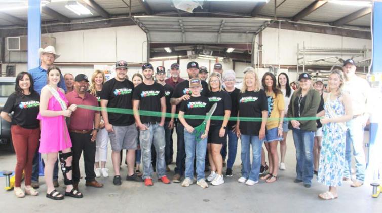 Wyndi Veigel-Gaudette | Citizen staff photo Bosco and Kayla Garrett, owners of Dublin Auto Repair, along with employees, friends, family and Dublin Chamber of Commerce board members, enjoy a grand opening celebration and ribbon cutting Saturday, April 13.