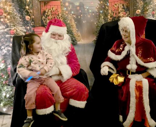 A child gleefully visits with Santa and Mrs. Claus at Doublin' In as part of the chamber's Cowboy Christmas event. Wyndi Veigel-Gaudette | Citizen staff photo
