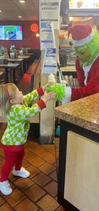 The Grinch visited the Dublin Dairy Queen Saturday, Dec. 21 and Mayhall Trucking sponsored free ice cream cones for kids. Despite his naturally Grinchy demeanor, the Grinch made many friends that day, and exchanged hugs and high fives with numerous people. Courtesy photos