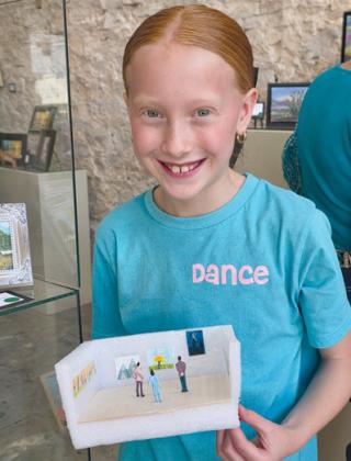 Artist Cora Derington shows off her mixed media art piece of a tiny art gallery. Wyndi Veigel-Gaudette | Citizen staff photo