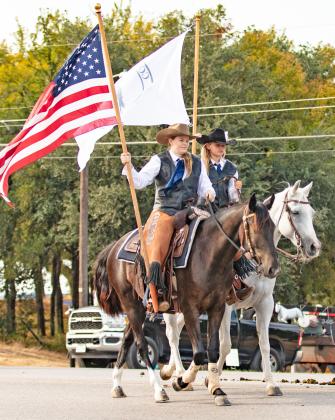 Above, Cowboy Capital Adventures showcases hunting supplies on a parade float. Right, horseback riders display flags while riding in the parade. For more parade photos see The Dublin Citizen Facebook page. Danielle Meador | Citizen staff photo