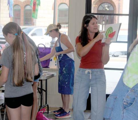Instructor Lauren Betancur leads students through a watercolor watermelon exercise during art camp. Wyndi Veigel-Gaudette | Citizen staff photo