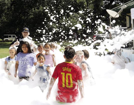 Dublin Police Officer Zoie Barnett cools off during the Back-to-School Fair Saturday, July 25 while enjoying some bubbles with the kids. For more photos see page A11 and The Dublin Citizen Facebook page. Wyndi Veigel-Gaudette | Citizen staff photo