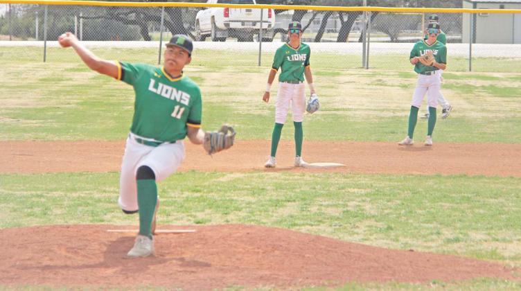 Dublin Lion Joe Salinas pitches from the mound in the Saturday, March 15 game against Peaster while teammates stand by to respond. Paul Gaudette | Citizen staff photo