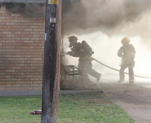 Firefighters battle their way through smoke to enter an apartment on Mesquite Street that was fully involved. As a result of the fire, Jackie Reed, 72, died. Other nearby apartments were impacted through smoke and water damage. Wyndi Veigel-Gaudette | Citizen staff photo