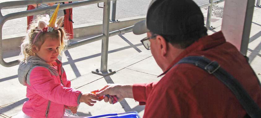 Charlie Bradberry, sitting outside of Blessings, hands out a piece of candy to a magical unicorn during the Safe Trick or Treat event Oct. 31. For more photos see our Facebook page. Paul Gaudette | Citizen staff photo