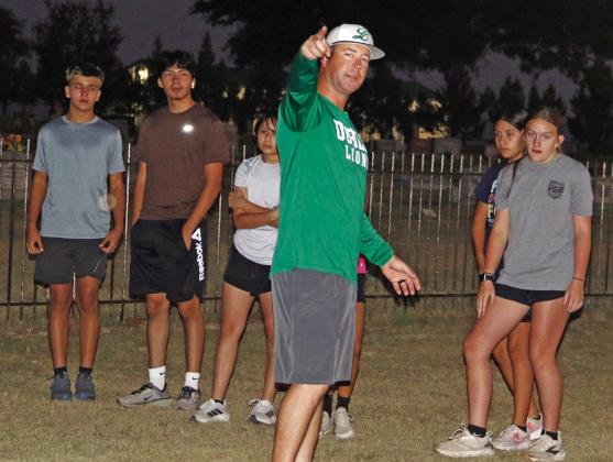 Lion and Lady Lion Cross Country runners were cheered on Monday, Aug. 3 as coaches Wes Grisham (below) and Jamel Anderson led the group on the first official day of practice. Paul Gaudette | Citizen staff photos