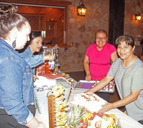 Prom organizers arrange a food table at Lingleville’s prom showcasing a beautifully made cake, drinks and other snacks for prom go-ers. Paul Gaudette | Citizen staff photo