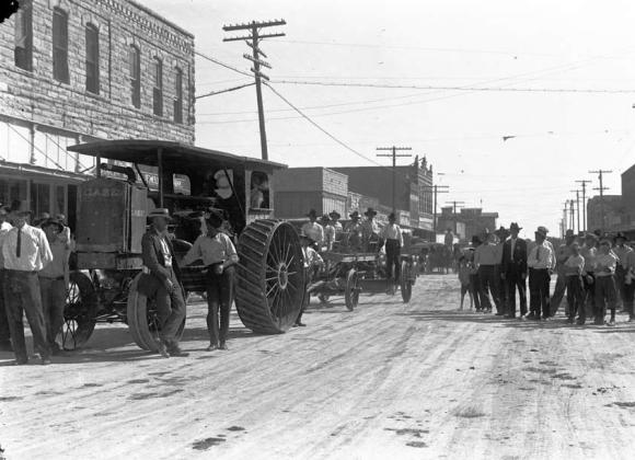 This early Case tractor was probably part of a parade around 1915 to 1917. It is pulling a blade that may have been used on early roads in Erath County.