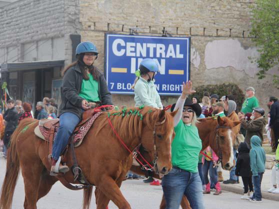 Wyndi Veigel and Paul Gaudette | Citizen staff photo Far right, Irishmen dressed in kilts lead a cry to action as they march in the parade with swords. Right, riders from Morning Star Ranch wave to the crowds in the annual St. Patrick’s Day parade.