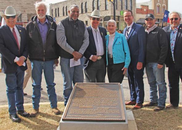 Scott and Carol Dissmukes, donors for the base of the Alamo letter plaque, stand center, with Erath County Commissioners, Erath and Hood County Judges and Erath Historical Commission members.