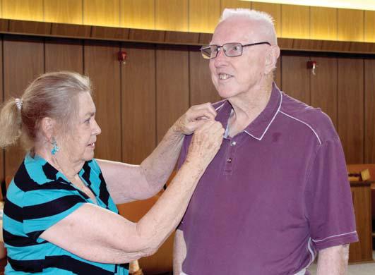 Dee White's 50 year pin is pinned on by his wife, Pat White. Wyndi Veigel-Gaudette | Citizen staff photo