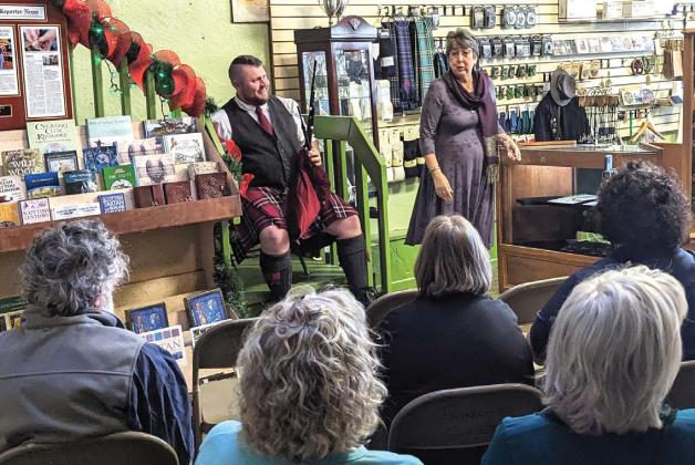 Bagpiper Jared Malone filled Dublin’s Things Celtic with some merry melodies on Saturday, Dec. 9. Above, Things Celtic owner Lanora Davidson addresses the listeners in the store, announcing they had more than 50 watching online as well. Malone then joked he needed to ‘break out his brogue’ accent for the crowd. Paul Gaudette | Citizen staff photo