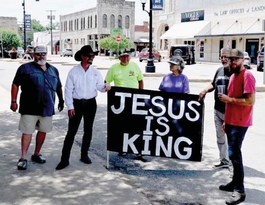 Jake Freels, an Erath County resident and Christian, displays a ‘Jesus is King’ sign at the protest event. Freels, and other supporters were there to offer peace, not a political statement. Jonathan Weiss | Hawke multimedia