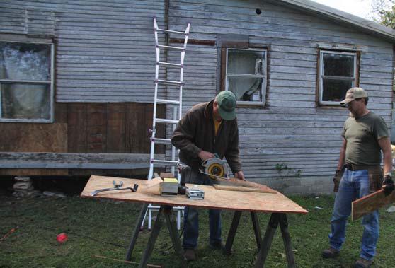 Volunteers work to cut boards to aid a family that needed their home winterized. Many volunteers from Cottonwood Baptist helped out. Paul Gaudette | Citizen staff photo