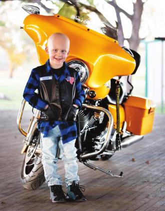 Rylan Pruitt poses in front of his family’s yellow Harley that he loved. The 6-year-old passed away last week following a tough battle with a rare form of cancer that inspired people from all over the world. Danielle Meador | submitted photo