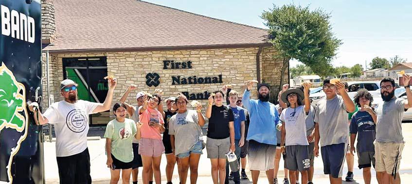 Dublin band members, leaders and boosters were treated to free pizza provided by Backwoods Saturday morning after they worked up a hunger in a car wash fundraiser in the First National Bank parking lot. | submitted photo