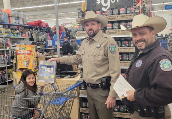 While being pushed around in a cart, Game Wardens aid a young lady in picking out a tablet. Wyndi Veigel-Gaudette | Citizen staff photo