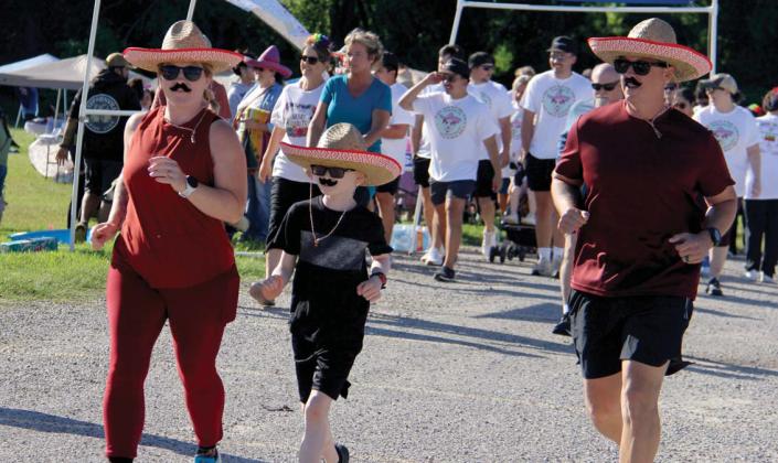 A family of mustached runners starts the annual Cinco de Mayo 5K and fun run benefitting the Erath County Humane Society. The annual event showcased a pet costume contest and vendors along with both a 5K and 1-mile fun run for both pets and humans alike. About $6,000 was raised in the event. Paul Gaudette | Citizen staff photo