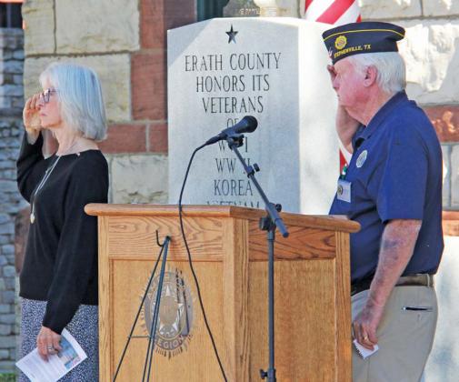 Wyndi Veigel-Gaudette | Citizen staff photo Brenda Guise and American Legion Post 240 Commander Keith Fredrickson salute as Taps is played at the Erath County Courthouse Veterans Day celebration.