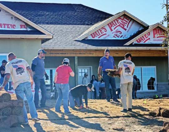 Volunteers work on the veteran’s home back in February. Paul Gaudette | Citizen staff photo