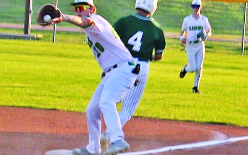 Dublin Lion Cayden Vanbebber leans in for a catch as a Breckenridge runner passes first base in the 3-2 home win Tuesday, March 24.