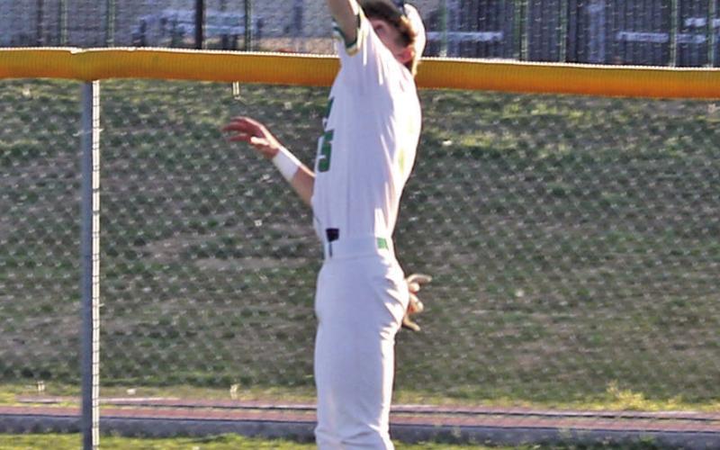 Dublin Lion Paxton Loper leaps up to score an out for the home team as they hosted Comanche Friday, March 20 on the Dublin diamond. Paul Gaudette | Citizen staff photo