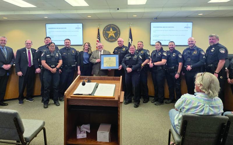 Members of the Stephenville Police Department along with city staff and others stand in solidarity as they are awarded Texas Best Practices Accreditation Tuesday, March 3. Below, from left is Stephenville Mayor Lonn Reisman, Retired Police Chief Kevin Lunsford, Program Manager for the Texas Best Practices Accreditation Program, Stephenville Police Chief Dan Harris and Stephenville City Manager Jason King receive the certificate for the accreditation. Wyndi Veigel-Gaudette | Citizen staff photo