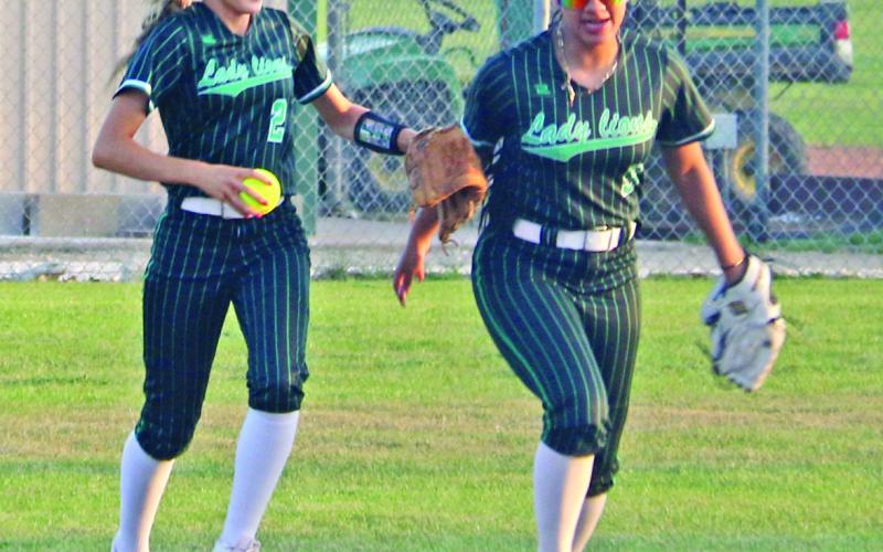 Lady Lions Tylor Nail and Adriana Stewart run in after an out while Regan Vanbebber catches a ball to knock out a Tolar runner before she reaches first base in a home game Tuesday, March 3. Paul Gaudette | Citizen staff photos