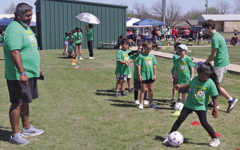 Volunteers work together to teach a soccer camp Saturday, March 21 at a Community Connection Cohorts event sponsored by a Texas Health Community Impact Grant. Dublin Family Worship ‘Feed My Sheep’ team provided free lunch for everyone and a variety of on-site community resources were also available at the Dublin Memorial Stadium. For more photos see The Dublin Citizen Facebook page and page 13. Paul Gaudette | Citizen staff photo