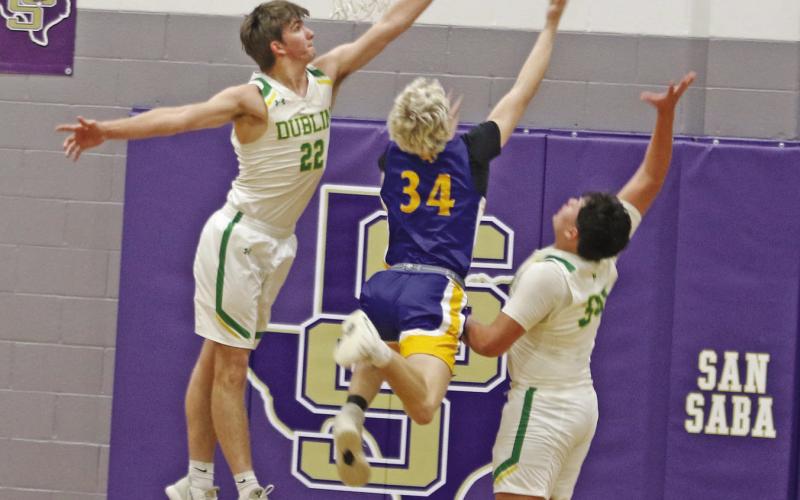 Dublin Lions Hunter Jones and Joe Salinas leaps up to block a shot from a Blanco ballcarrier in the Area playoff game held Friday, Feb. 27 in San Saba. Paul Gaudette | Citizen staff photo