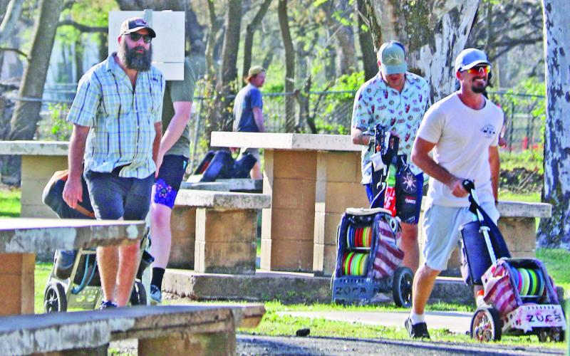 A group of disc golfers walks across the park to the next hole as they play a round of golf. For information about disc golf, contact Dublin Disc Golf Club on Facebook. Wyndi Veigel-Gaudette | Citizen staff photo