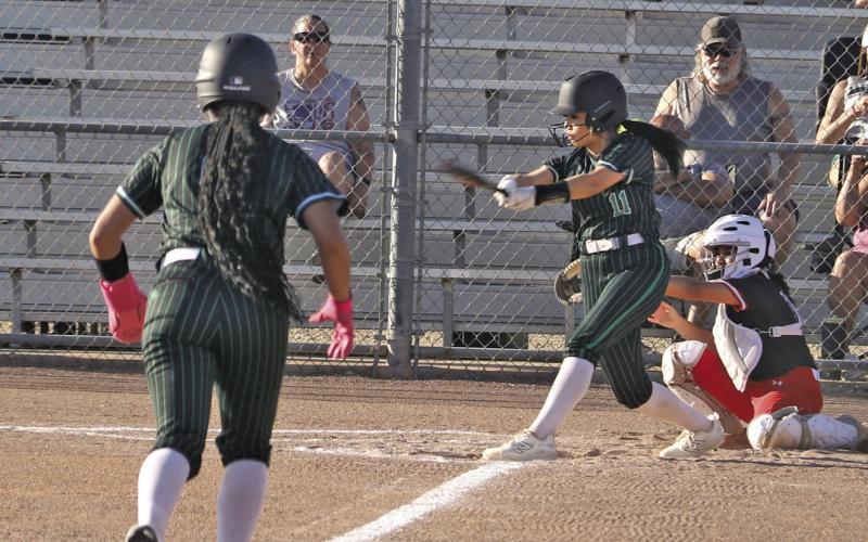Dublin Lady Lion Adriana Stewart steps off third to head for home as Izzy Cervantes swings in the home game against Eastland Friday, March 20. Paul Gaudette | Citizen staff photo