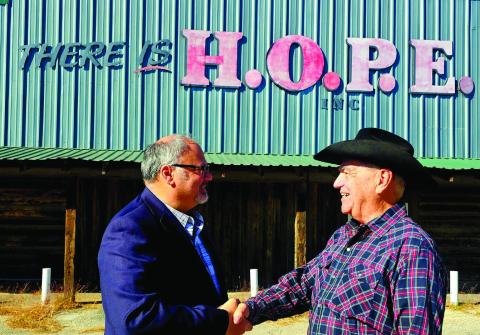 Erath County Democratic Party Chairman Moumin Quazi and Erath County Republican Party Chairman Dave Washam shake hands as the parties work together in a fight against hunger. Courtesy photo