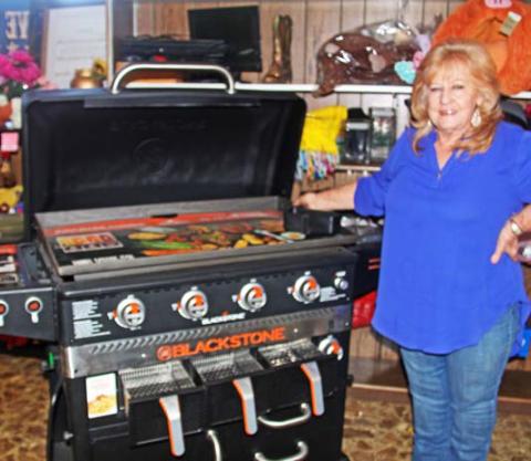 Cheryl Moore of Stephenville Cattle Company shows off a Blackstone Grill donated by the Dowell Company/ Ace Hardware for the Oct. 26 Round-Up for Rehab auction. Paul Gaudette | Citizen staff photo