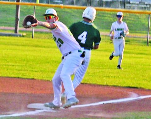 Dublin Lion Cayden Vanbebber leans in for a catch as a Breckenridge runner passes first base in the 3-2 home win Tuesday, March 24.