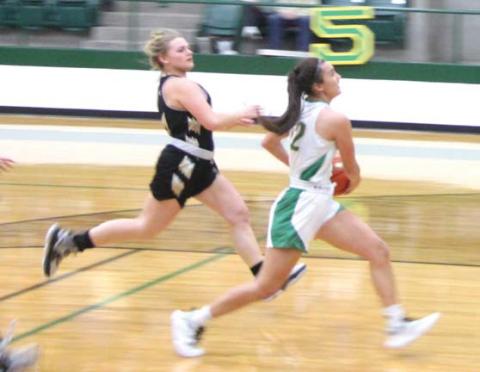Paul Gaudette | Citizen staff photo Dublin Lady Lion Emma Vargas (above) outpaces a Comanche Maiden during the Jan. 10 home game. Madilyn Loper springs up to catch the ball before taking it to the hoop.