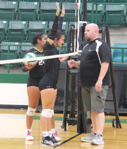 Senior Emma Vargas and Sophomore Adriana Stewart attempt to intimidate Athletic Booster Club President Ryan Mitchell before the start of the alumni vs Lady Lions games Tuesday, Aug. 20. The alumni teams beat both JV Green and Gold but fell (despite some creative scoring) to the Varsity Lady Lions. Below, the alumni team gathers to take on the Lady Lions. For full story see B1. Paul Gaudette | Citizen staff photos