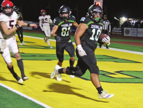 Dublin Lion Mosiah Lolohea brings in a touchdown on Friday against Eastland (above) while a host of Mavericks fight to bring down Christian Ramirez. Paul Gaudette | Citizen staff photo
