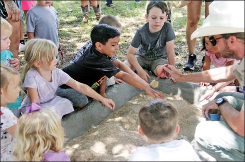 Kids of all ages enjoy digging into some dino fun at the Dublin Public Library Thursday, June 27 with Park Rangers from Dinosaur Valley State Park in Glen Rose. Students and adults alike got to hear about fossils found at the park, unearth some fossils outside and enjoy some popsicles courtesy of library staff. For more photos see the Dublin Citizen Facebook page. Reese Keeling I Citizen staff photo
