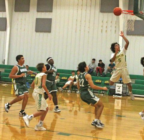 Dublin JV Green Lions square up with Breckenridge JV under the net during a home game Friday night in Gym 3. Tha games ended in a win for the visitors. Paul Gaudette | Citizen staff photo