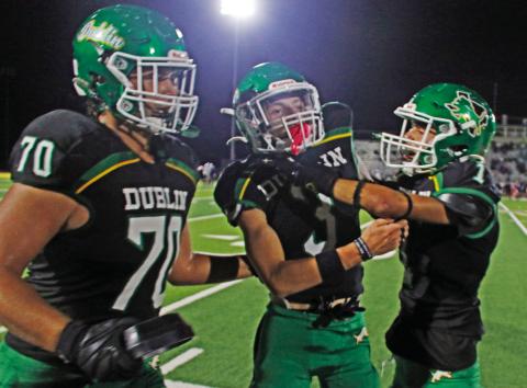Dublin Lion Kyler Gaitan greets teammate Hudsen Joslin at the sideline with spirit after Joslin completes a catch and brings in 6 points for the home team on Cervetto Field Friday, Oct. 17. Jayden Balvantin also gives Joslin a pat on the back after completing the PAT kick. Paul Gaudette | Citizen staff photo