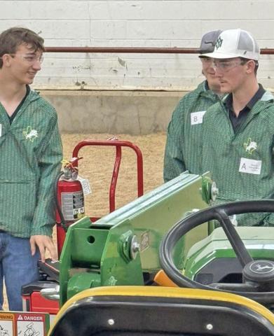 Paul Gaudette | Citizen staff photo Ethan Whitaker, Cody Maddux, and Riley Kemp under the direction of Blake Padgett represented Dublin FFA in the Tractor Technician Area contest. In the contest, groups take a test, problem solve, and work together to solve a set of issues with a specific tractor.