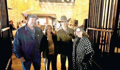 City and Chamber of Commerce representatives congratulate Dalton Kasel (second from right) on his rodeo success on the fi rst anniversary of Dalton Kasel Day, Tuesday, Jan. 13. The resolution was presented at Doublin’ In’s weekly Open Mic night.