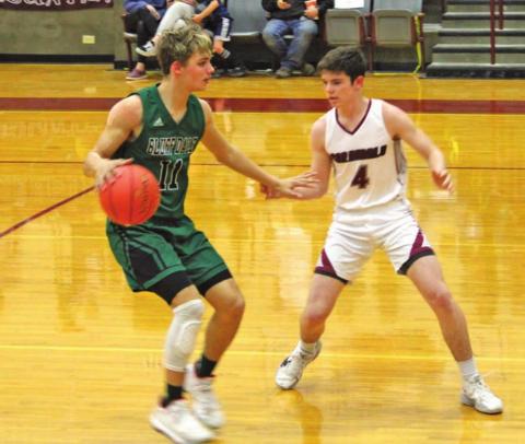 Lingleville Cardinal Kyler Philips moves to block an advancing Bluff Dale Bobcat during Friday’s home game. Sara Gann | Citizen staff photo