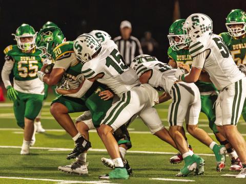 Dublin Lion Joe Salinas draws a string of Santo Wildcats as he moves to rush the ball up field in the Sept. 4 home game. Danielle Meador | Citizen staff photo