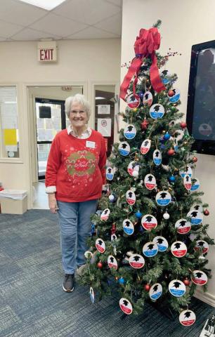 Cynthia Butler with Teha Lana Chapter of the Daughters of the American Revolution stands next to the Patriots tree at the Dublin Public Library showcasing the names of patriots that fought in the American Revolutionary War. Courtesy photo