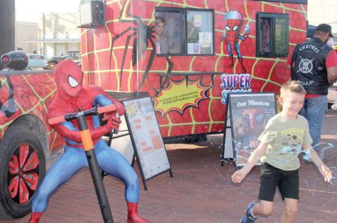 Wyndi Veigel | Citizen staff photo Spider-man from Denton sprays an eager kid with silly string at the inaugural Rylan Strong Network Car and Bike show in Dublin Saturday, Aug. 27. The network founded in honor of 6-year-old Rylan Pruitt helps fund kids and families battling childhood cancer.