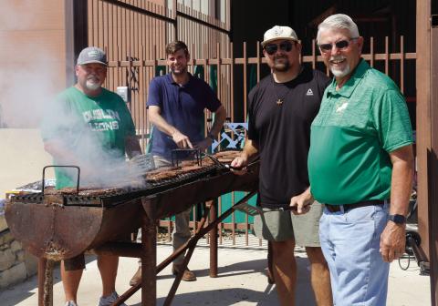 The Dublin Rotary Club and First National Bank of Dublin representatives prepare hamburgers for the concession stand at the Homecoming football game Friday, Sept. 28. Wyndi Veigel-Gaudette | Citizen staff photo